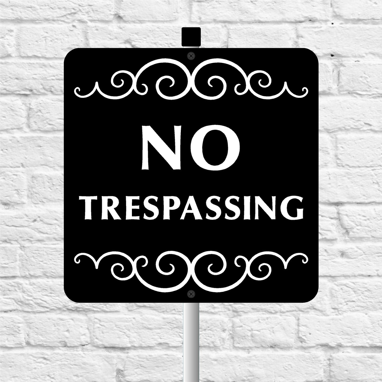No Trespassing sign with decorative elements on a white brick background