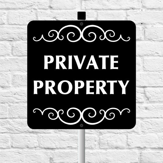 Black 'PRIVATE PROPERTY' sign with decorative elements on a white brick wall background