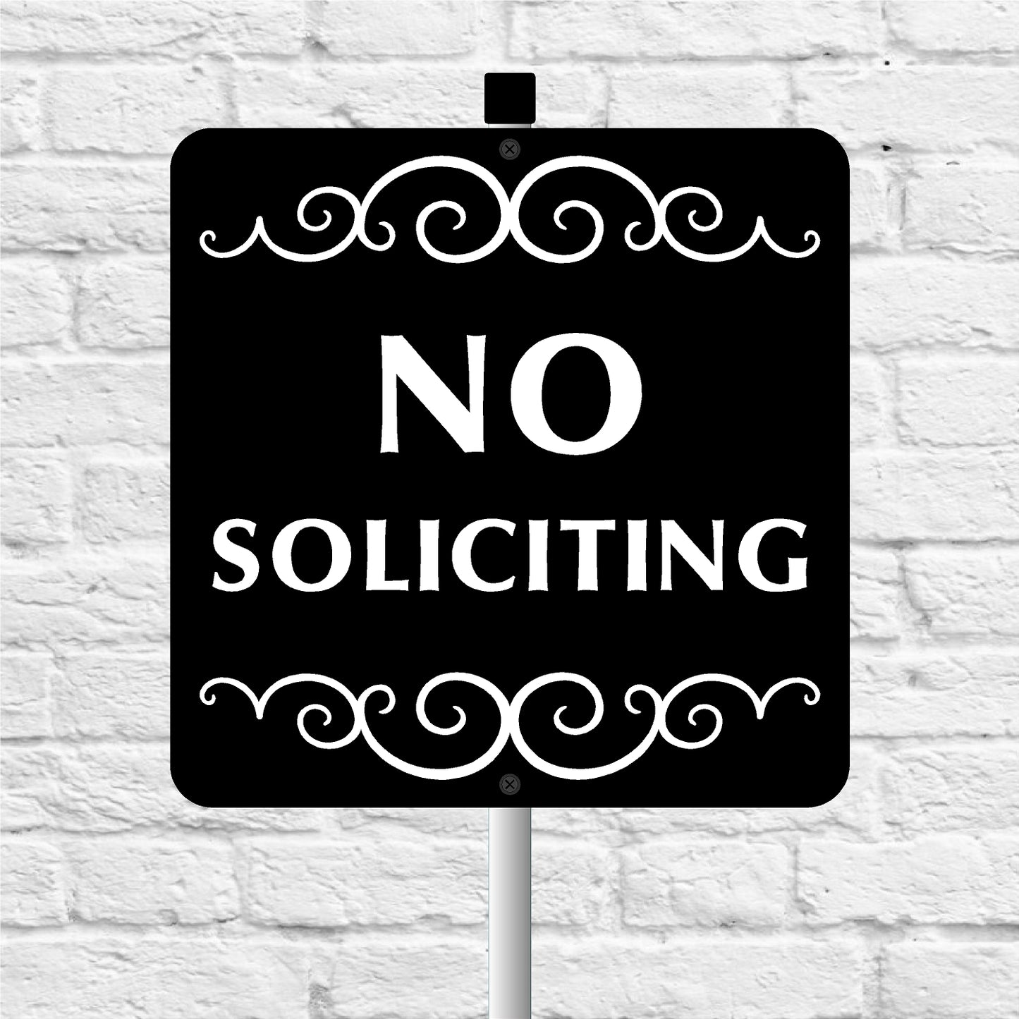 No soliciting sign with decorative elements on a white brick wall background