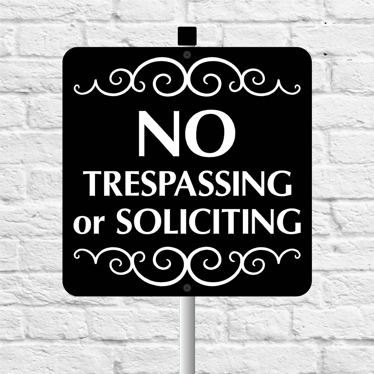 No Trespassing or Soliciting sign with decorative elements on a white brick background