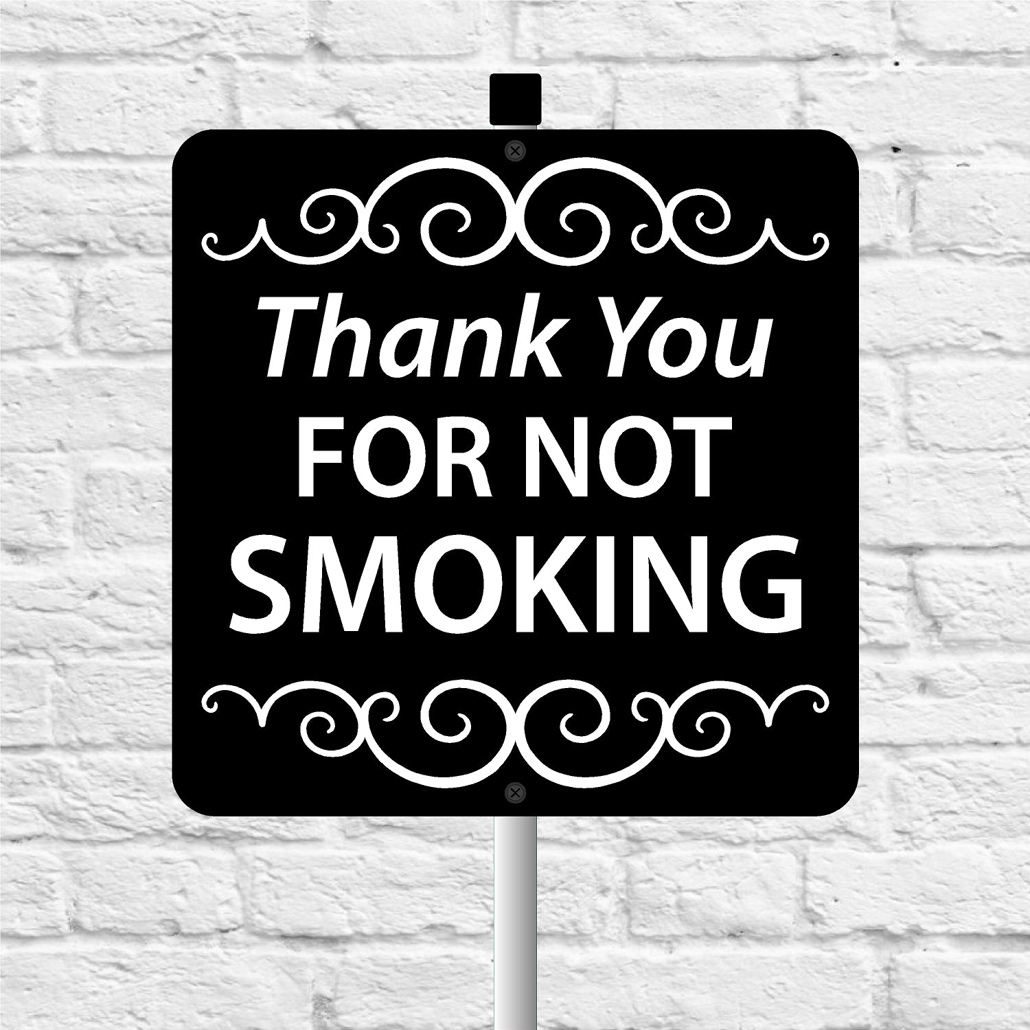 Sign with 'Thank You FOR NOT SMOKING' text on a white brick background
