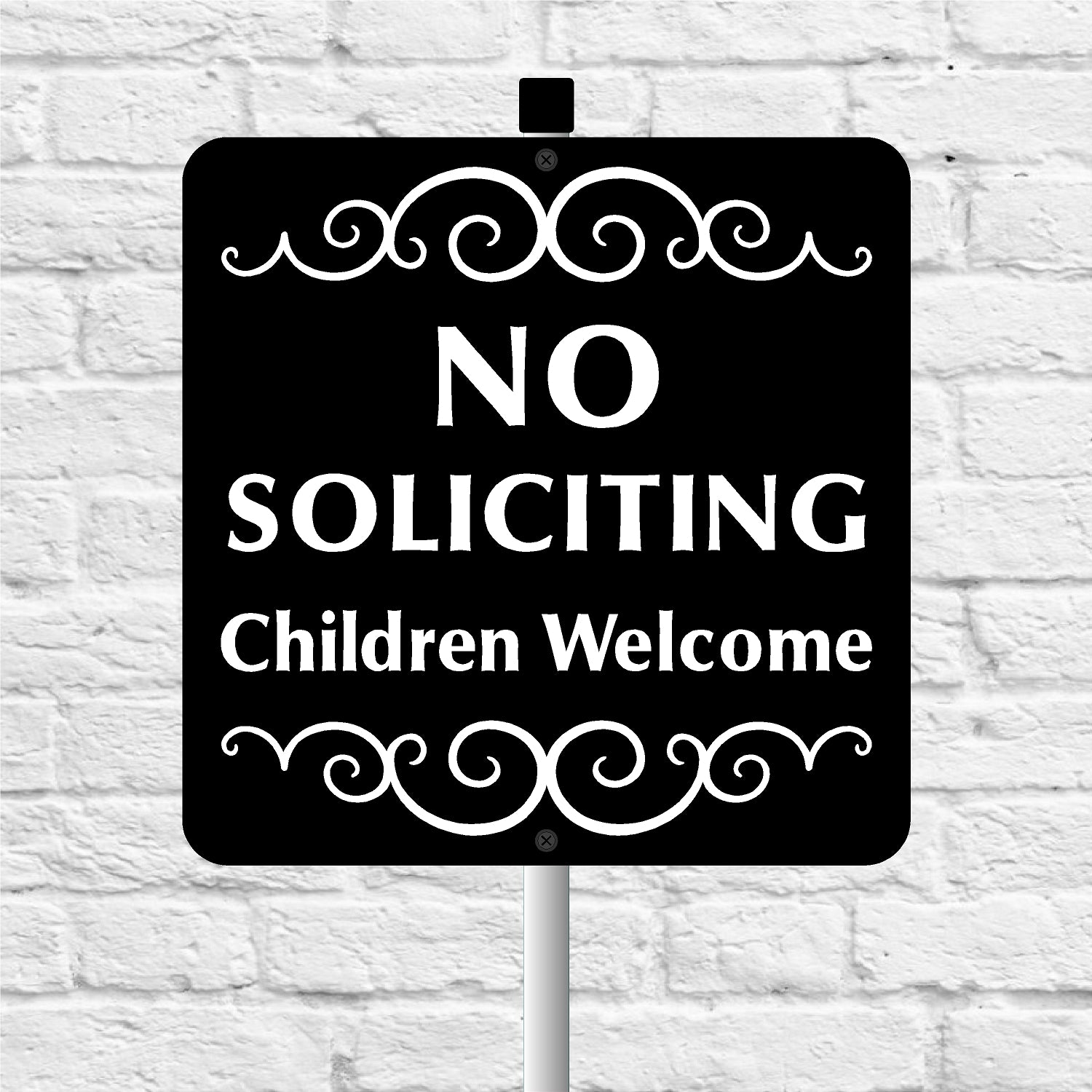 No Soliciting Children Welcome sign on a white brick background