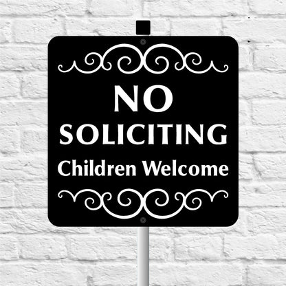 No Soliciting Children Welcome sign on a white brick background