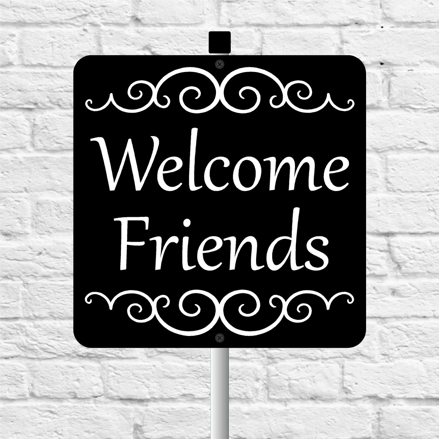 Black sign with 'Welcome Friends' text on a white brick wall background
