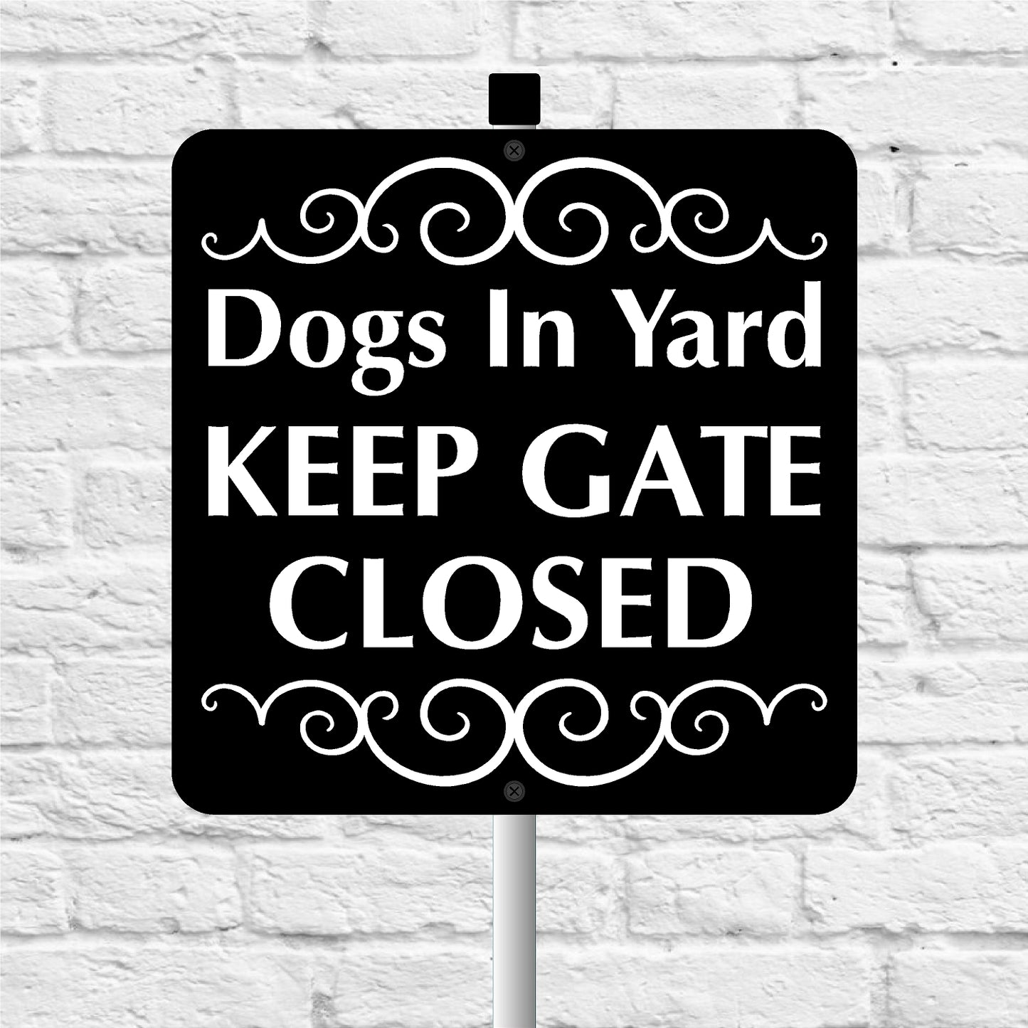 Sign with 'Dogs In Yard KEEP GATE CLOSED' text on a white brick background
