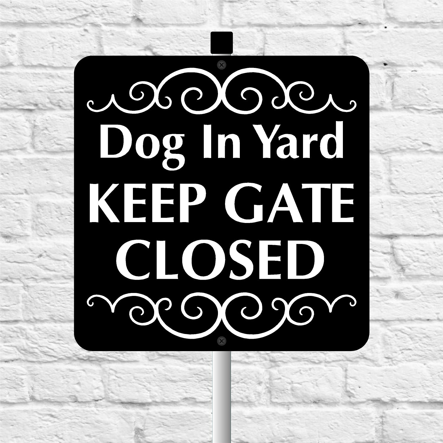 Sign with text 'Dog In Yard KEEP GATE CLOSED' on a white brick background
