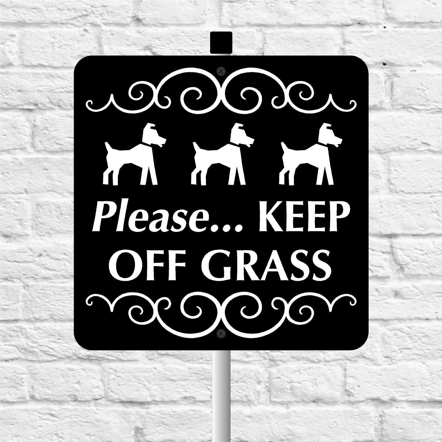 Black keep of grass sign with white text and dog illustrations against a white brick wall background
