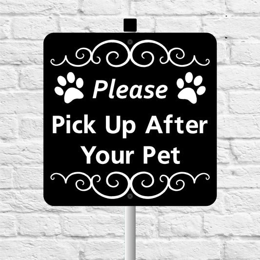 Black sign please pick up after your pet with white text and paw prints on a white brick wall background