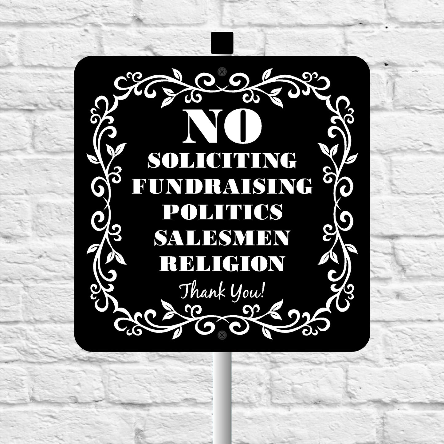 Black sign with white text and decorative border on a white brick wall background