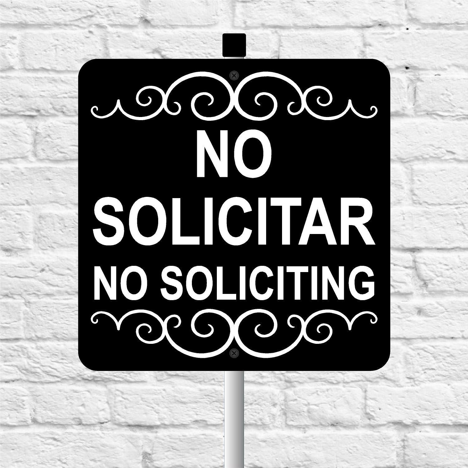 No soliciting sign with decorative elements on a white brick wall background