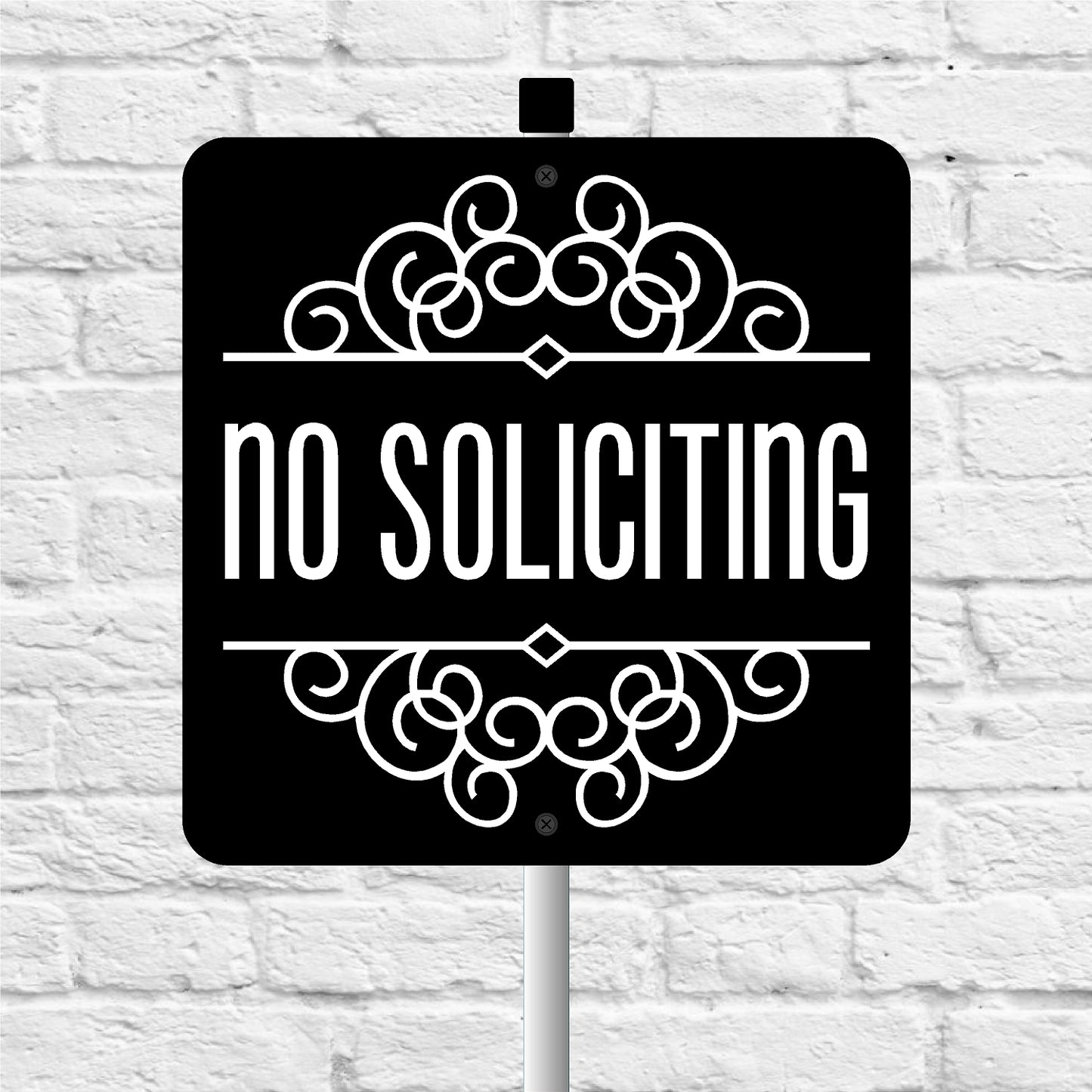 No soliciting sign with decorative elements on a white brick background