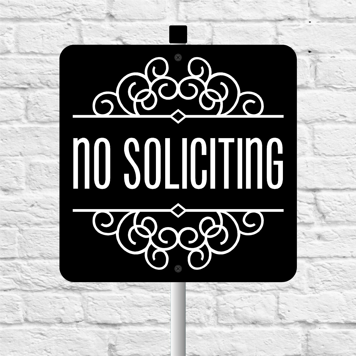 No soliciting sign with decorative elements on a white brick background