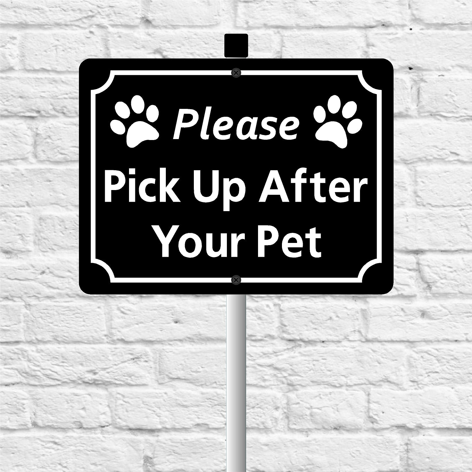 Sign with 'Please Pick Up After Your Pet' text on a white brick wall background