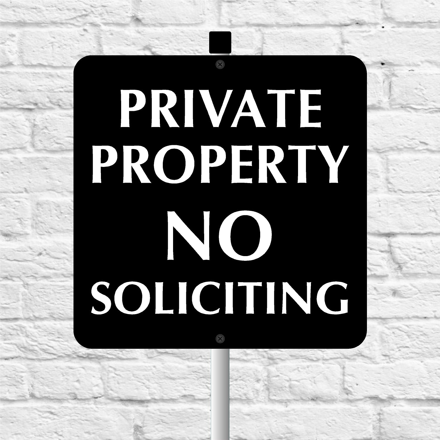Black and white 'Private Property No Soliciting' sign against a light gray brick wall.