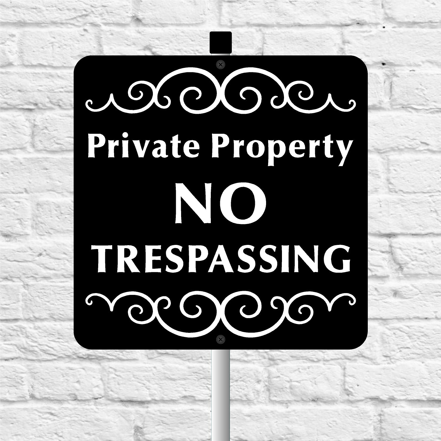 Black and white 'Private Property No Trespassing' sign on a white brick background