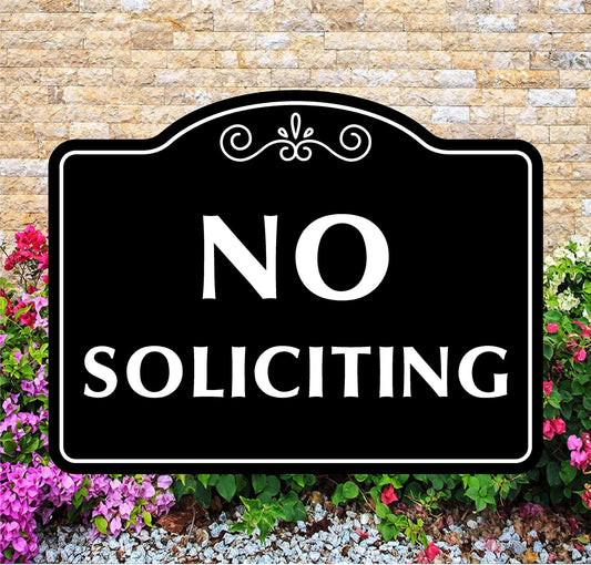 No Soliciting sign with decorative border on a stone wall background