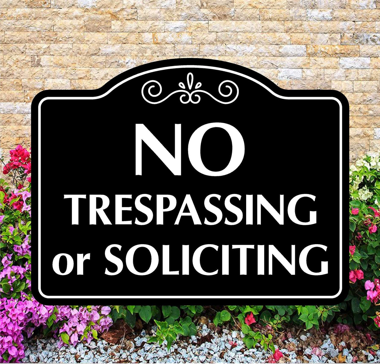 No Trespassing or Soliciting sign with decorative elements on a stone wall background.