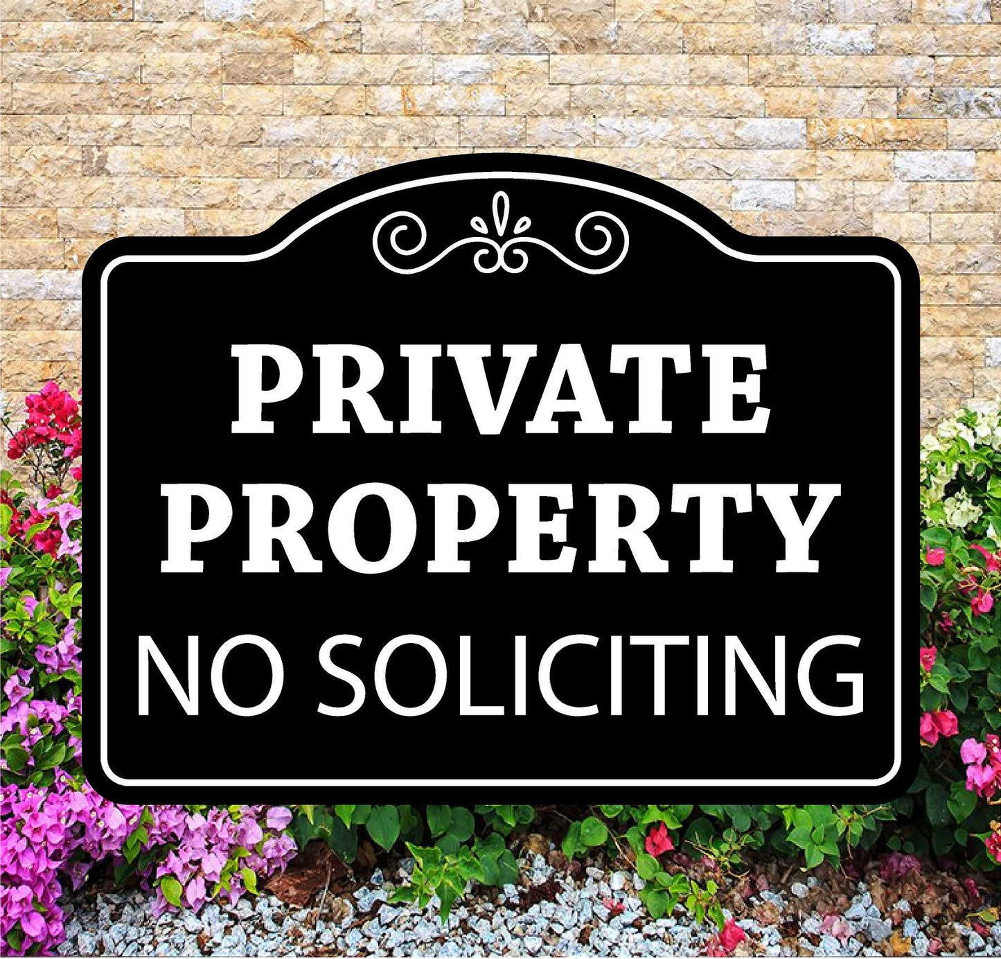 Black and white 'Private Property No Soliciting' sign in front of a brick wall and flowers.