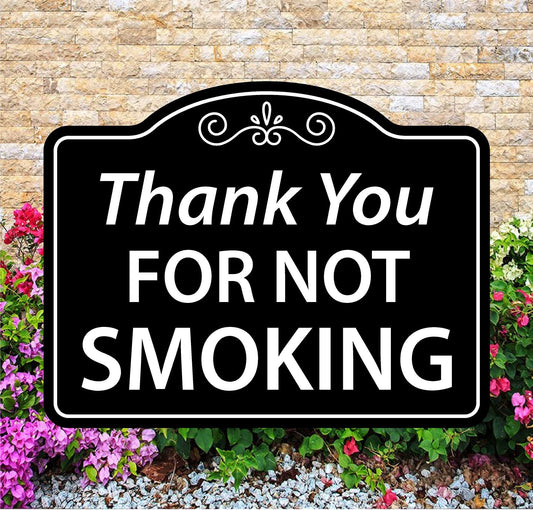 Decorative sign with 'Thank You FOR NOT SMOKING' text against a brick wall and floral background