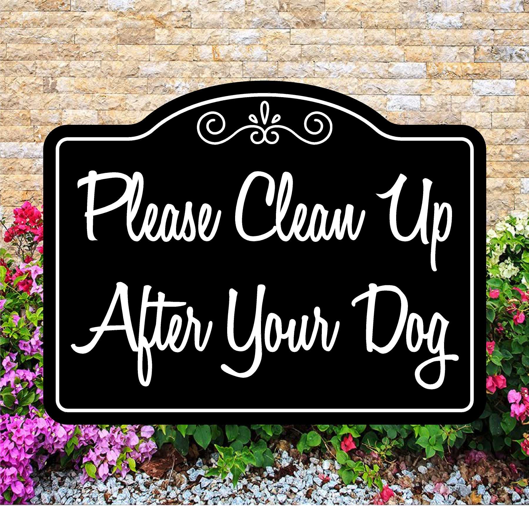 Decorative sign with 'Please Clean Up After Your Dog' text in front of a brick wall and flowers.