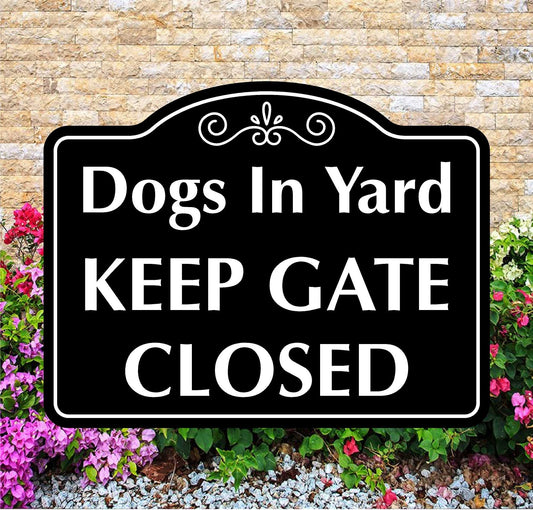Sign with 'Dogs In Yard KEEP GATE CLOSED' text on a decorative border against a brick wall and flower background.