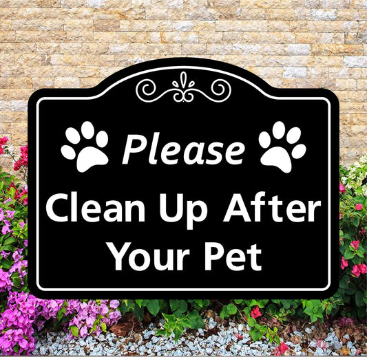 Decorative sign with paw prints and text 'Please Clean Up After Your Pet' against a stone wall and flower background.
